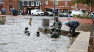 The Kunta Kinte-Alex Haley Memorial and the road behind it are flooded near high tide at City Dock in downtown Annapolis, Md., on Friday, Oct. 29, 2021. The National Weather Service is warning that the mid-Atlantic region could see one of the biggest tidal floods of the last decade or two as heavy rain and winds pummel the region on Friday. (AP Photo/Brian Witte)