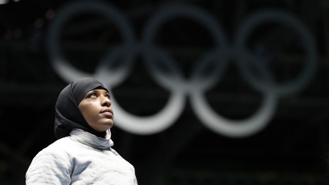 FILE- In this Aug. 8, 2016, file photo, Ibtihaj Muhammad, from United States, waits for match against Olena Kravatska from Ukraine, in the women's saber individual fencing event at the Summer Olympics in Rio de Janeiro. Members of basketball's international governing body are expected to vote to eliminate a rule that bans religious headgear during competition. The vote could come during a meeting on Thursday or Friday, May 5, 2017. Headgear was banned for safety reasons two decades ago out of fear it could fall off, causing a player to slip or become entangled. (AP Photo/Vincent Thian, File)