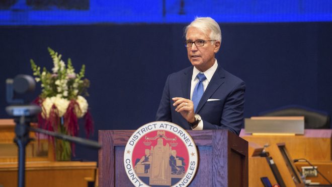 In this photo provided by the County of Los Angeles, incoming Los Angeles County District Attorney George Gascon speaks after he was sworn in during a mostly-virtual ceremony in downtown Los Angeles Monday, Dec. 7, 2020. Gascon, who co-authored a 2014 ballot measure to reduce some nonviolent felonies to misdemeanors, has promised more reforms to keep low-level offenders, drug users and those who are mentally ill out of jail and has said he won't seek the death penalty. (Bryan Chan/County of Los Angeles via AP)