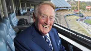 FILE - In this Tuesday, Sept. 20, 2016, photo, broadcaster Vin Scully poses for a photo prior a baseball game between the Los Angeles Dodgers and the San Francisco Giants in Los Angeles. The Hall of Fame broadcaster, whose dulcet tones provided the soundtrack of summer while entertaining and informing Dodgers fans in Brooklyn and Los Angeles for 67 years, died Tuesday night, Aug. 2, 2022. He was 94. (AP Photo/Mark J. Terrill)